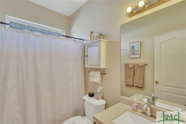 bathroom with toilet, vanity, and a shower with curtain