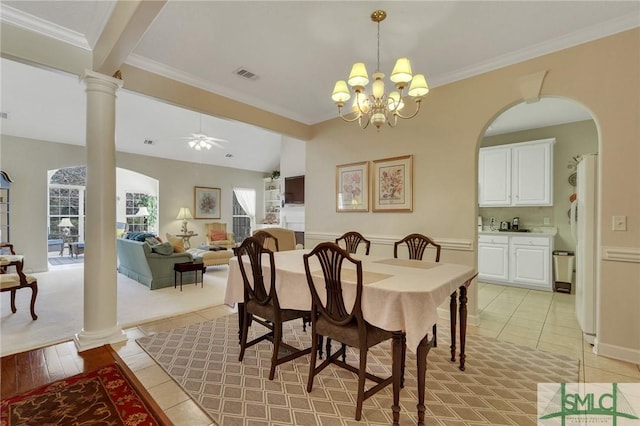 dining space with ceiling fan with notable chandelier, ornamental molding, decorative columns, and visible vents