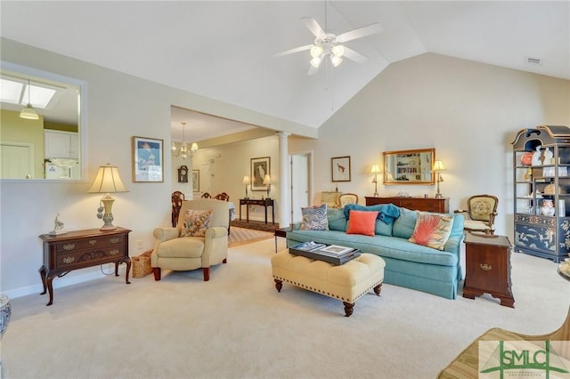 living room with high vaulted ceiling, carpet flooring, ornate columns, and ceiling fan with notable chandelier