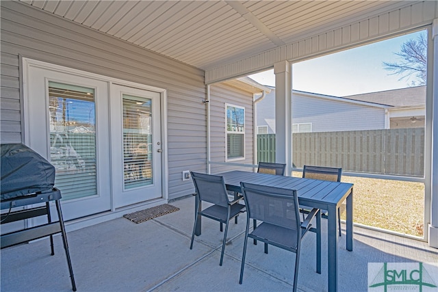 view of patio with fence and outdoor dining space