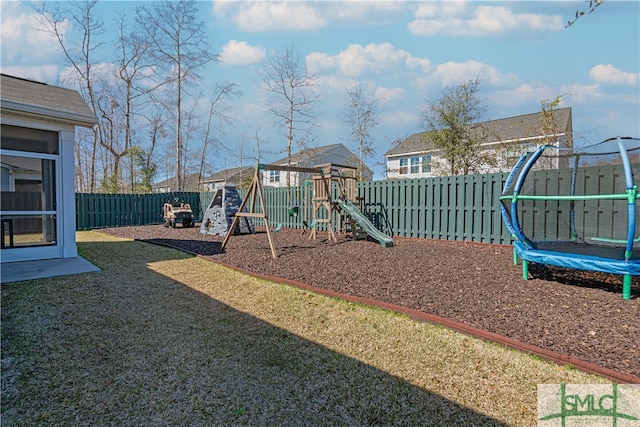 community play area with a trampoline and a fenced backyard