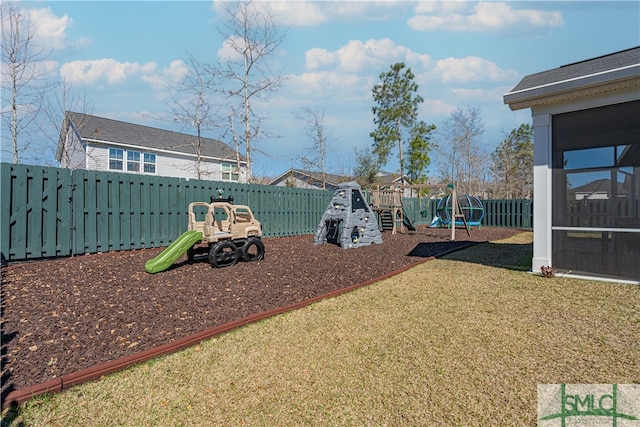 community jungle gym featuring a yard and a fenced backyard