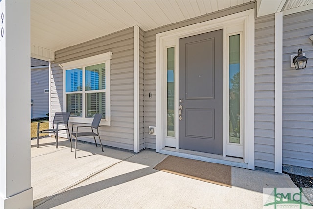 entrance to property featuring covered porch