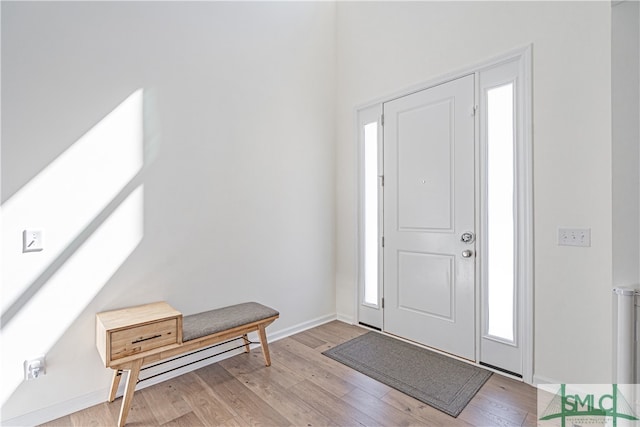 entryway featuring light wood-type flooring and baseboards