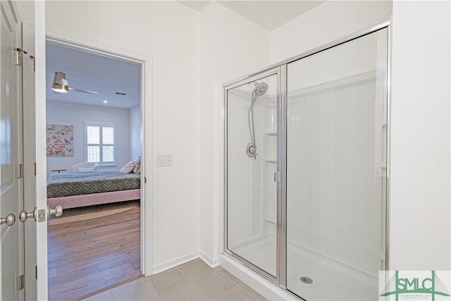 ensuite bathroom featuring wood finished floors, a stall shower, ensuite bath, and visible vents