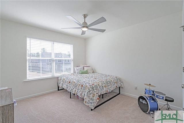 carpeted bedroom with baseboards and a ceiling fan