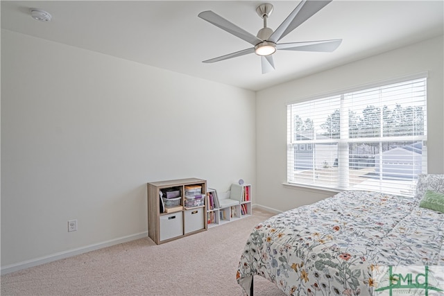 carpeted bedroom featuring ceiling fan and baseboards