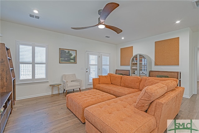 living room featuring a healthy amount of sunlight, light wood-style floors, visible vents, and recessed lighting