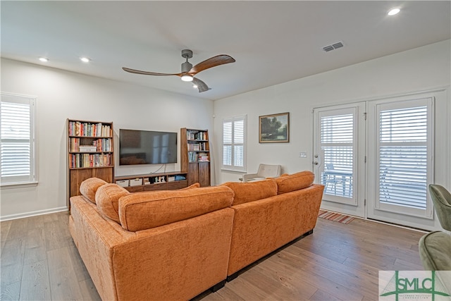 living room featuring baseboards, visible vents, ceiling fan, wood finished floors, and recessed lighting