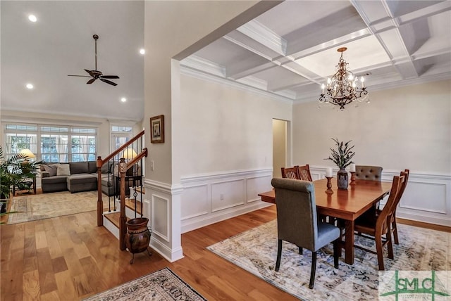 dining area featuring stairs, beam ceiling, coffered ceiling, and wood finished floors