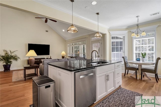 kitchen featuring a center island with sink, visible vents, light wood-style flooring, stainless steel dishwasher, and a sink