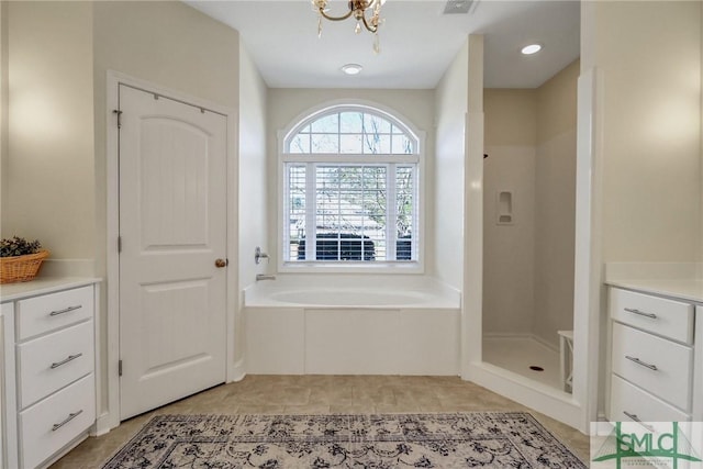 bathroom featuring a notable chandelier, visible vents, a stall shower, tile patterned flooring, and a bath