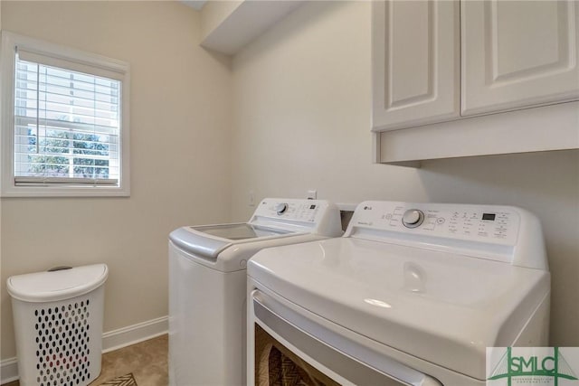 laundry room with cabinet space, baseboards, and washing machine and clothes dryer