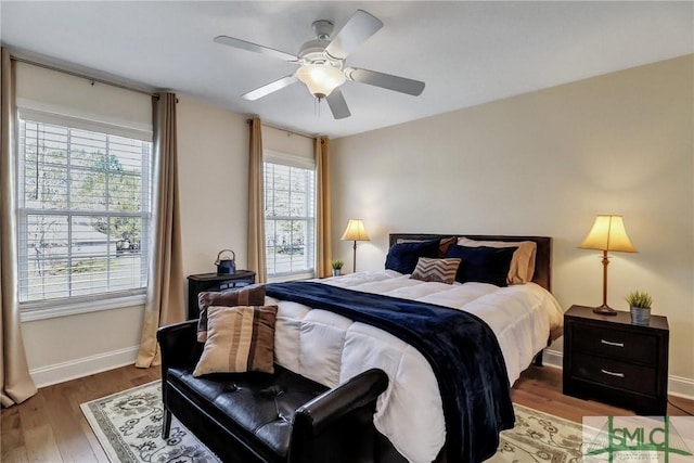 bedroom with ceiling fan, baseboards, and wood finished floors