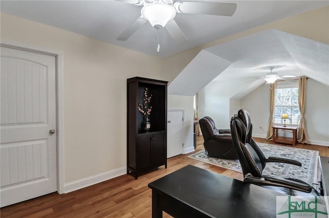 office space with ceiling fan, baseboards, vaulted ceiling, and wood finished floors