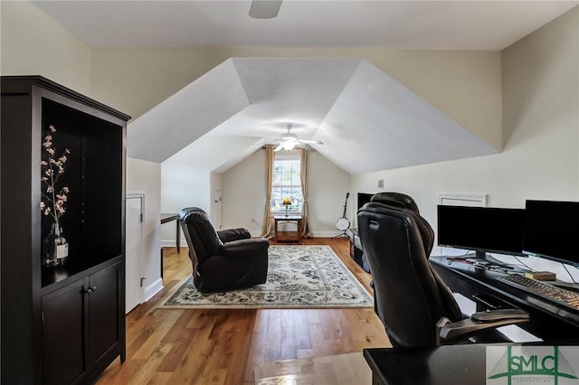 home office with lofted ceiling, ceiling fan, baseboards, and wood finished floors