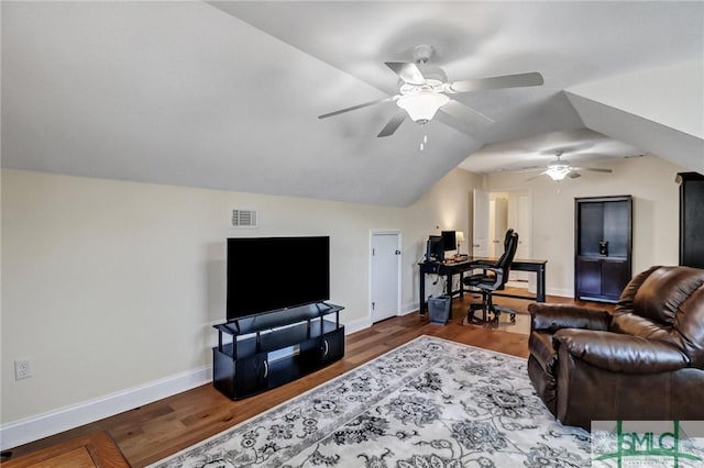 living room with lofted ceiling, baseboards, visible vents, and wood finished floors