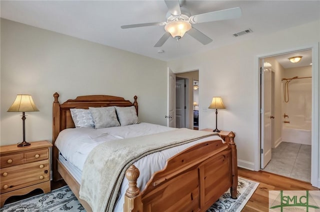 bedroom with connected bathroom, visible vents, ceiling fan, and light wood finished floors