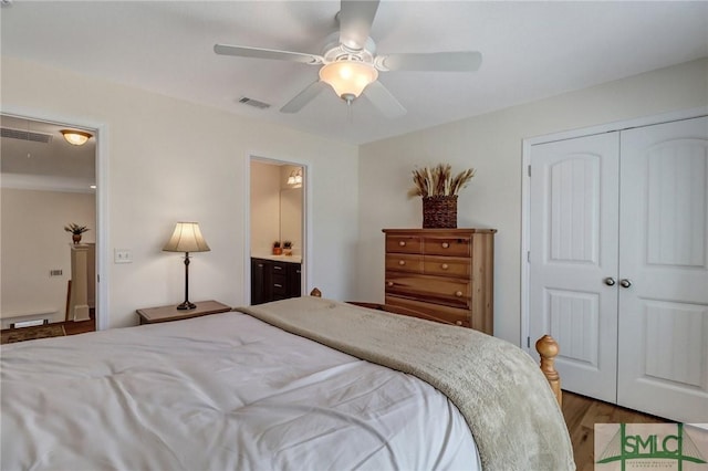 bedroom with ceiling fan, a closet, wood finished floors, and visible vents