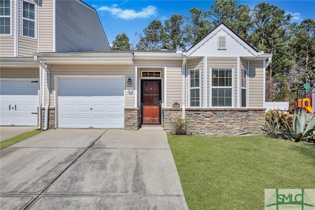 view of front of home with a garage, driveway, and a front lawn