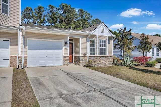 single story home featuring driveway, stone siding, a garage, and board and batten siding