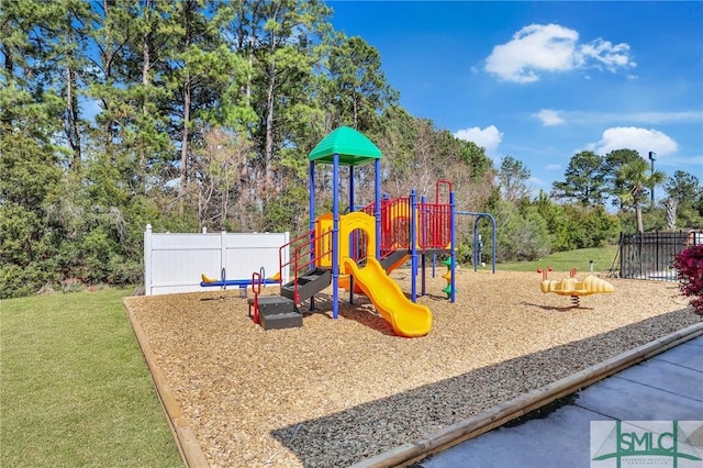 community playground with fence and a lawn