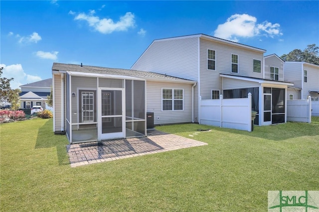 back of house featuring a sunroom, a yard, a patio, and fence