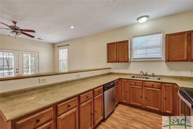 kitchen with stainless steel appliances, brown cabinets, and a sink