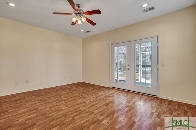 empty room featuring visible vents, baseboards, light wood-style flooring, french doors, and recessed lighting