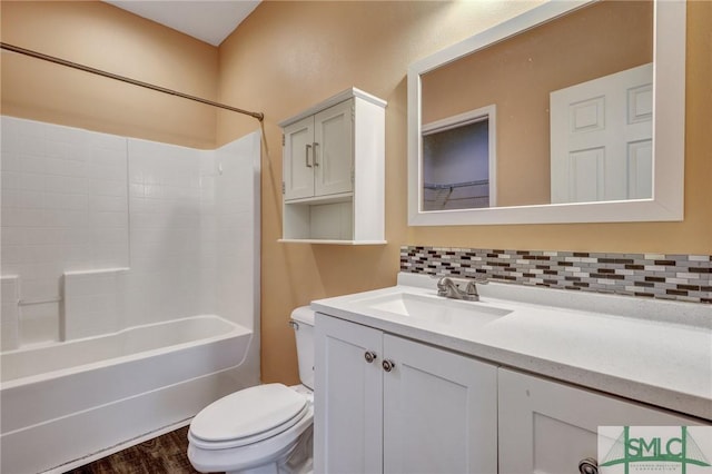 full bathroom with toilet, tub / shower combination, backsplash, and vanity