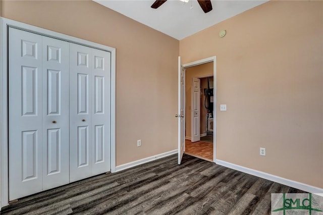 unfurnished bedroom with ceiling fan, a closet, dark wood finished floors, and baseboards