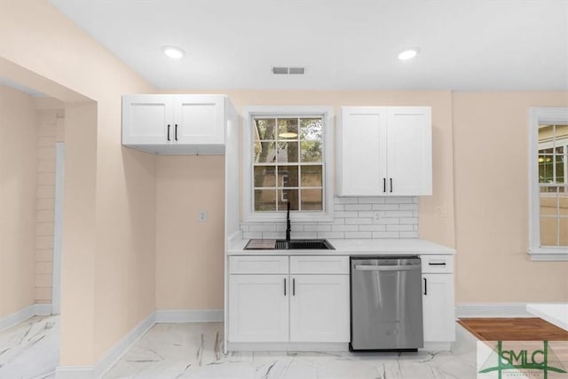 kitchen with a sink, marble finish floor, decorative backsplash, and stainless steel dishwasher