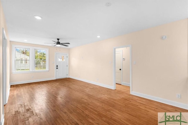 unfurnished living room featuring a ceiling fan, baseboards, wood finished floors, and recessed lighting