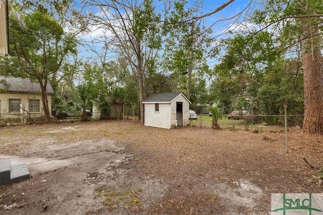 view of yard featuring a shed, an outdoor structure, and a fenced backyard