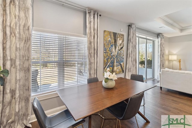 dining area with crown molding, baseboards, and wood finished floors