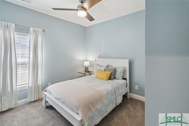 bedroom with multiple windows, carpet, and baseboards