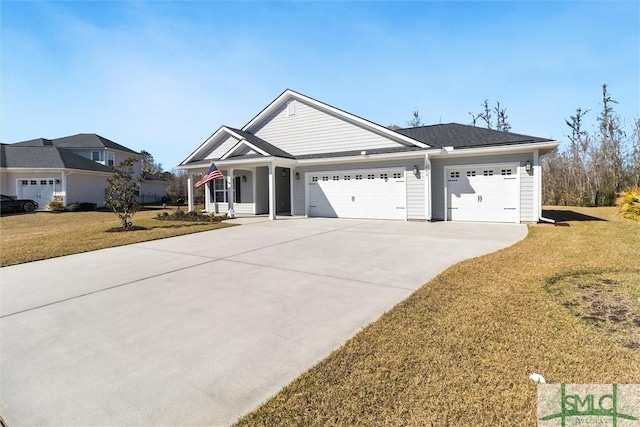 view of front of home featuring an attached garage, concrete driveway, and a front yard