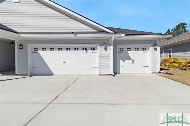 garage with concrete driveway