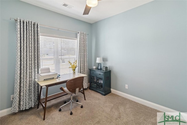 office space featuring carpet, visible vents, ceiling fan, and baseboards