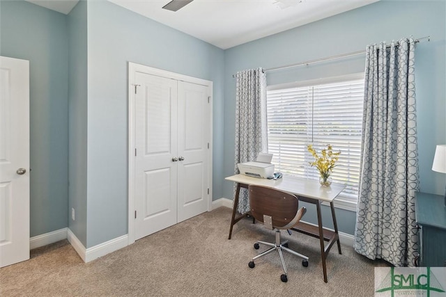 carpeted home office with baseboards