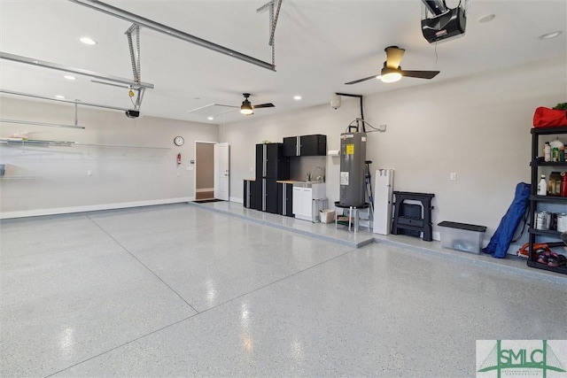 garage featuring water heater, ceiling fan, and a garage door opener