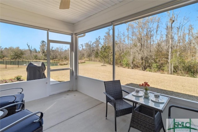 sunroom / solarium featuring ceiling fan