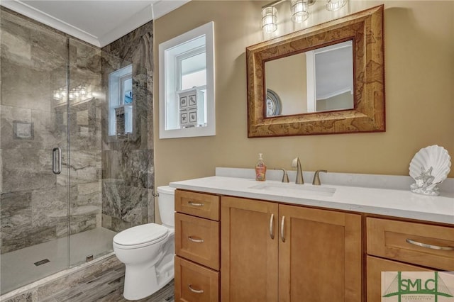 full bathroom with toilet, a shower stall, wood finished floors, and vanity