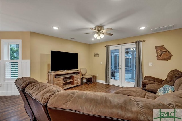 living area with dark wood-style floors, french doors, visible vents, and recessed lighting