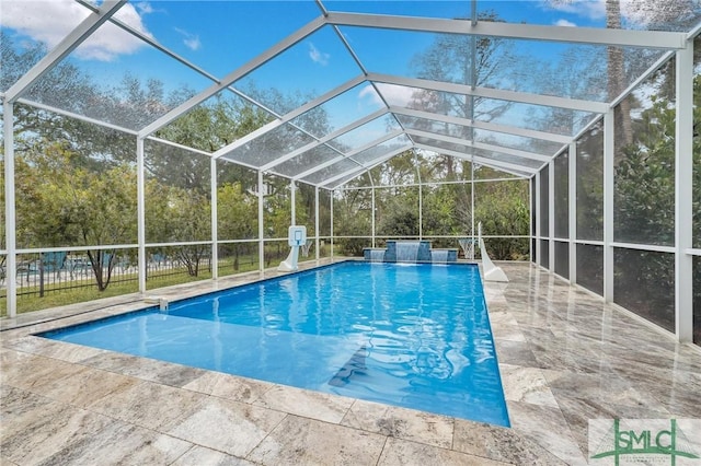 view of swimming pool with a fenced in pool, glass enclosure, and a patio area