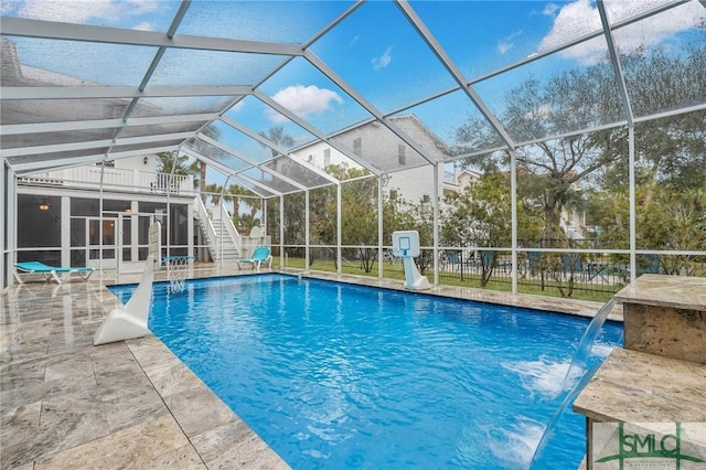 view of swimming pool featuring a lanai, fence, a fenced in pool, and a patio