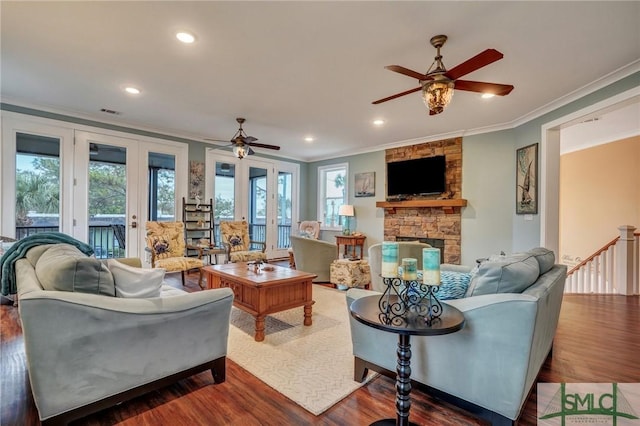 living room with crown molding, plenty of natural light, and wood finished floors