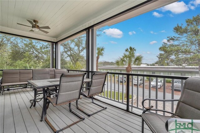 wooden deck featuring a ceiling fan and outdoor dining area