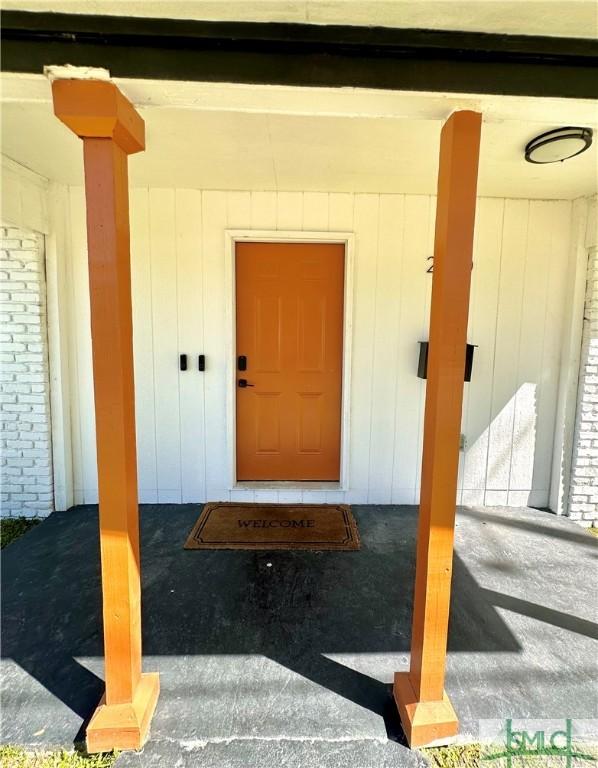 property entrance featuring brick siding