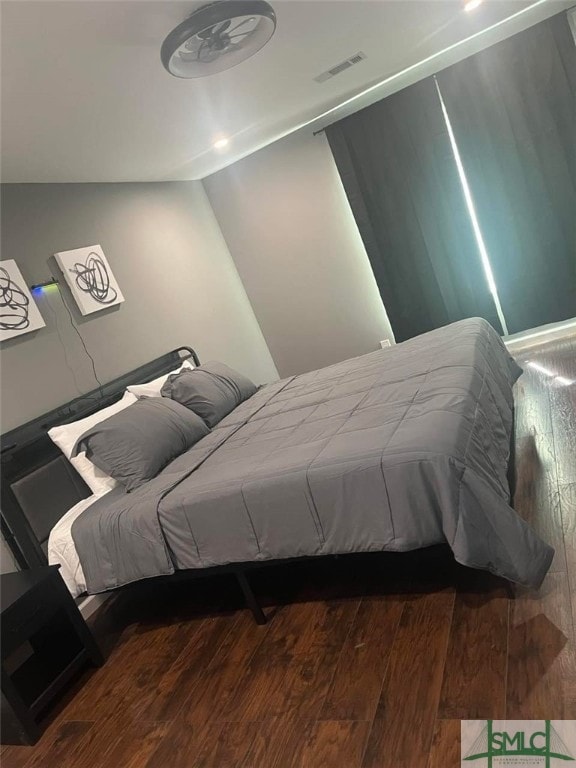 bedroom with visible vents and wood finished floors